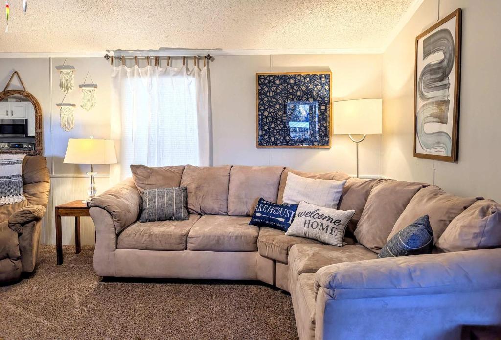 a living room with a sectional couch with pillows at Rough River Lake Cabin Fishing in Fentress McMahan