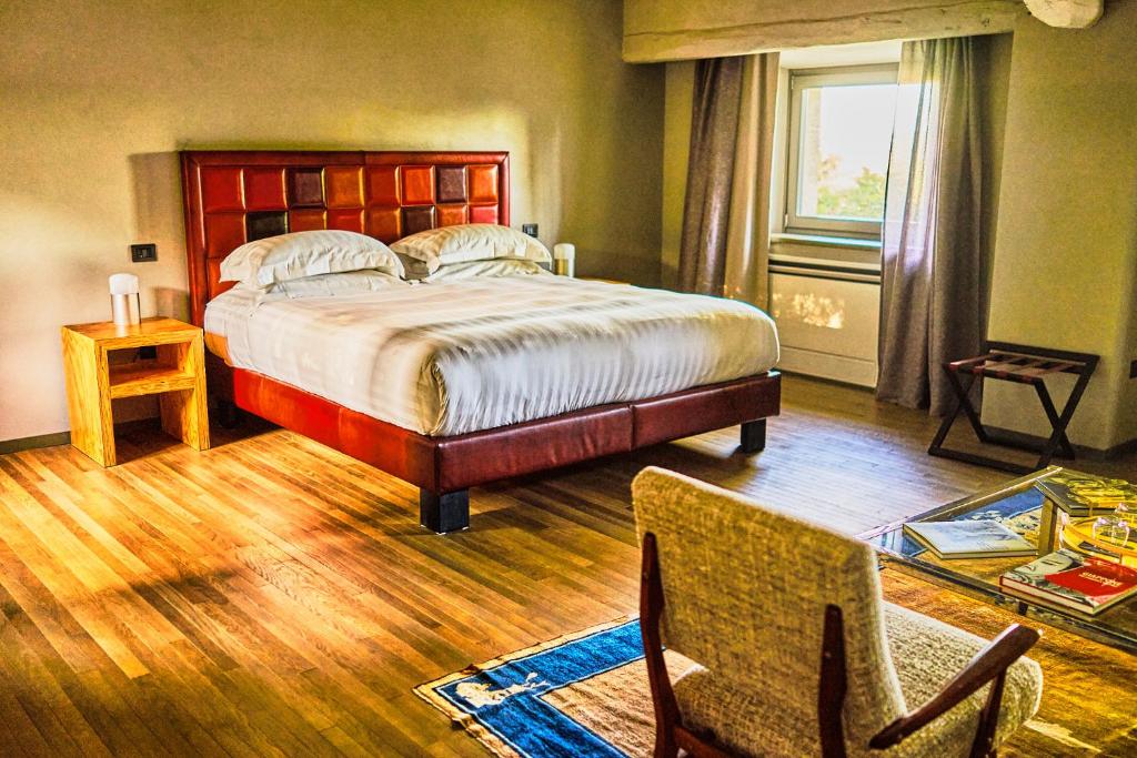 PalazzoneにあるGodiluvaの大きなベッドと椅子のある寝室