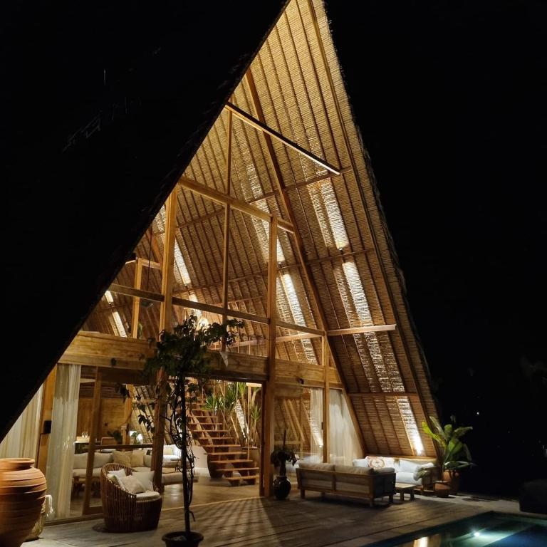 a large room with a large ceiling with windows at The Sawah Lodge, Seseh-Bali in Seseh