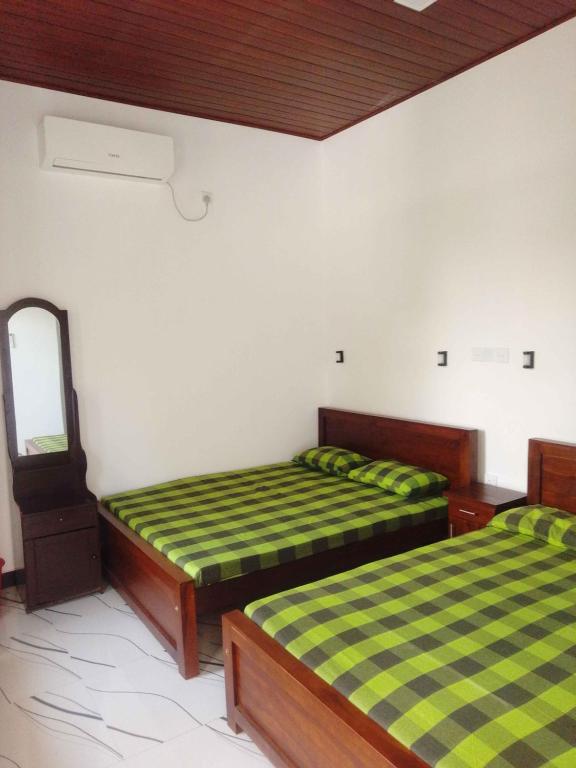 Ένα ή περισσότερα κρεβάτια σε δωμάτιο στο Ceylon Green Gate Hotel