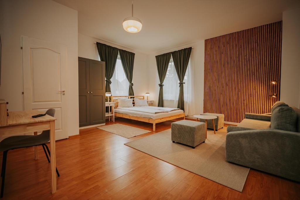 a living room with a couch and a bed at Kossuth Apartments in Gheorgheni