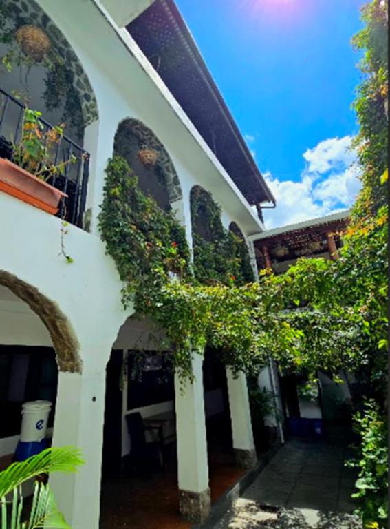 a building with ivy growing on the side of it at Casa de la Torre in Antigua Guatemala
