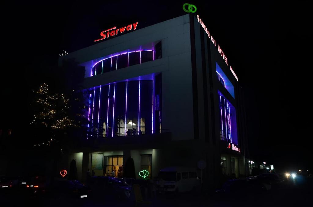 a building with a sony sign on it at night at Starway Hotel in Lankaran