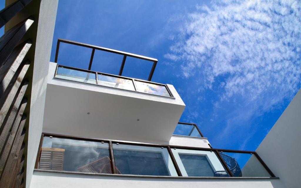 a building with windows looking up at the sky at Flamingo Beach House in Santa Luzia