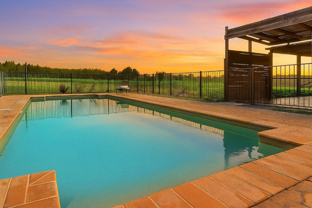 a swimming pool in a backyard with a fence at Stay at Shiraz in Belford