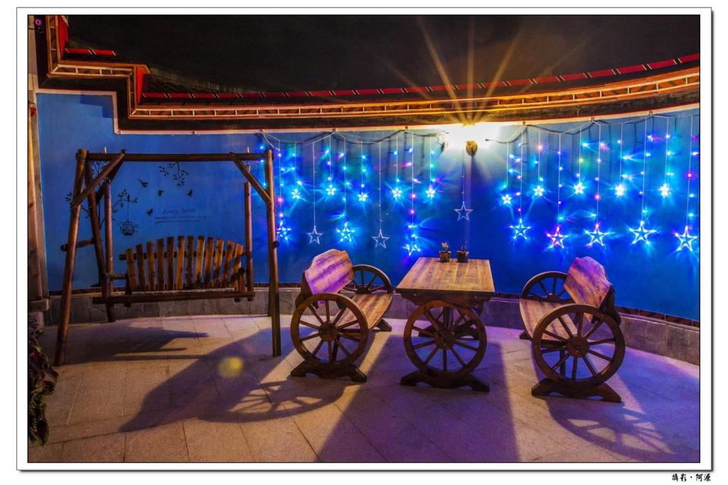 a stage with a table and blue lights at Zhu Shan Grandee B&B in Jincheng