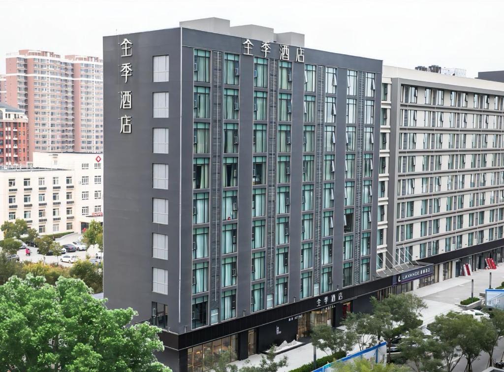 a tall gray building with chinese writing on it at JI Hotel Beijing Changyang Subway Station in Fangshan