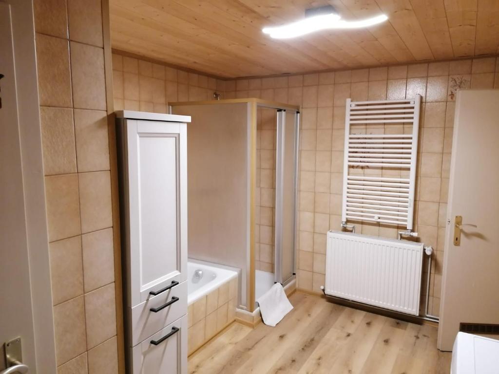 a bathroom with a tub and a toilet and a window at Hause Alpina in Bichlbach