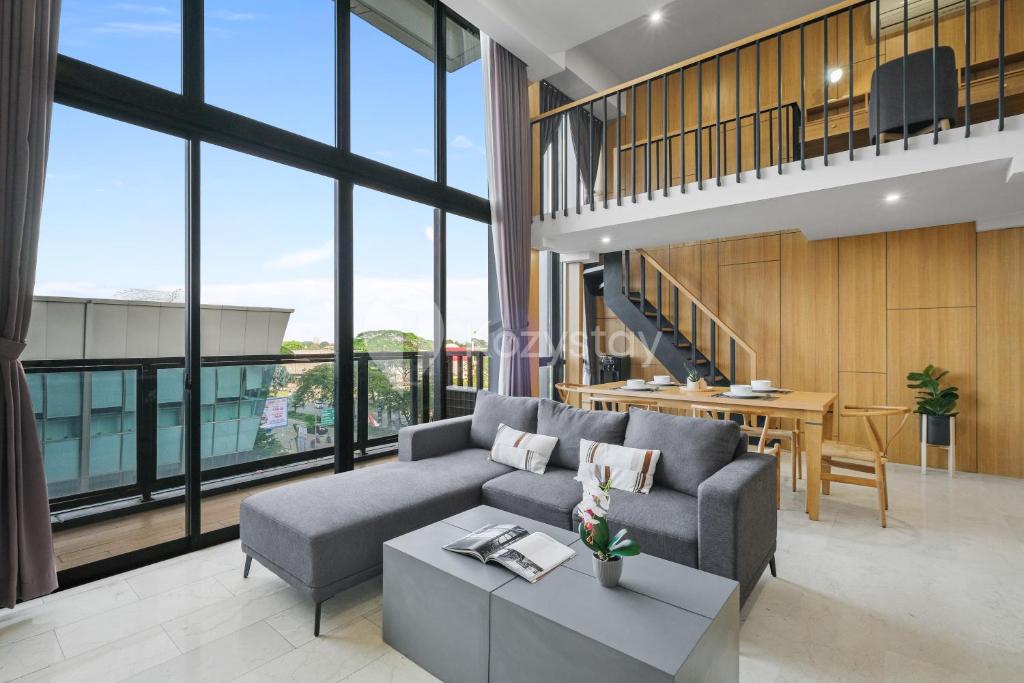 a living room with a couch and a table at Minori by Kozystay - Alam Sutera in Dongkal Dua