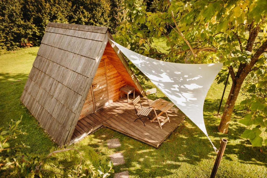 a dog house with a banner hanging from it at Glamping Bizjak in Preddvor