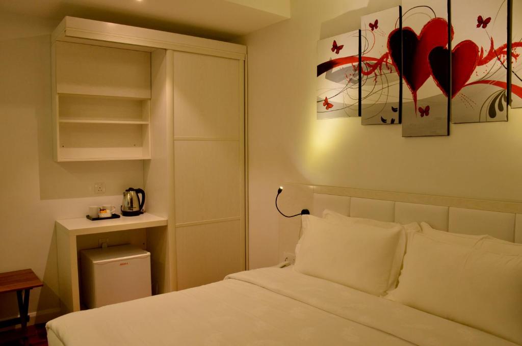 Postel nebo postele na pokoji v ubytování Pine Garden Hotel