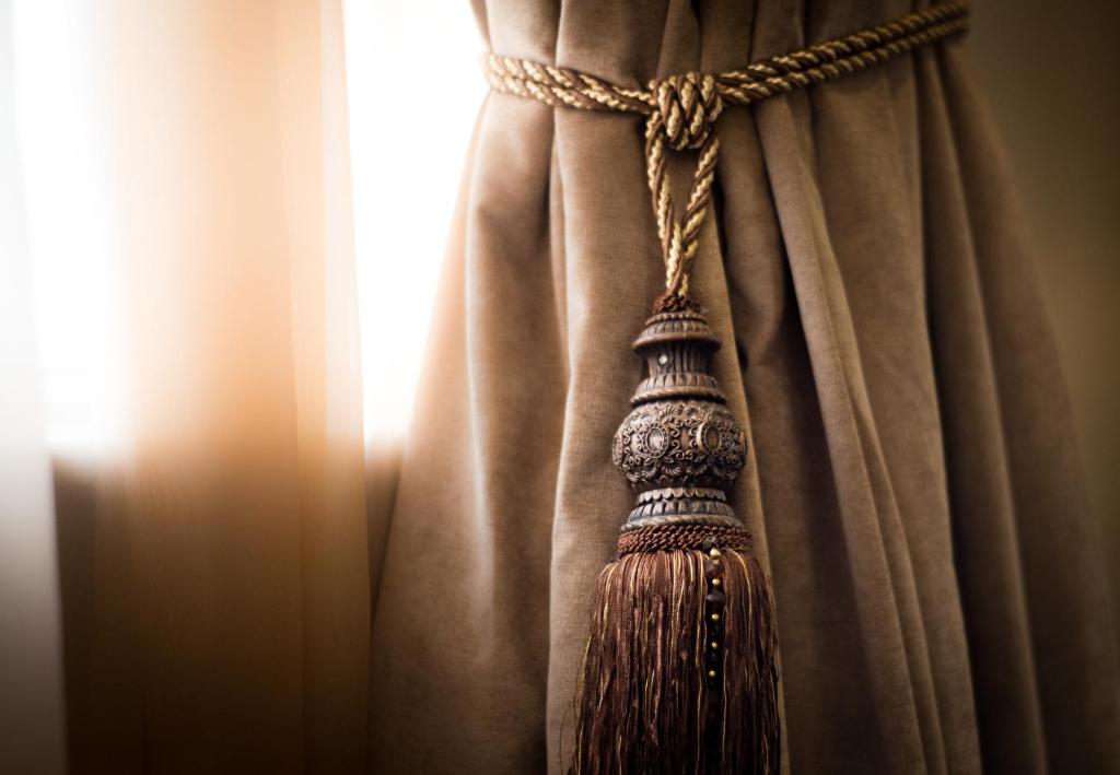 a broom hanging from a curtain at Luxus Grand Hotel in Lahore