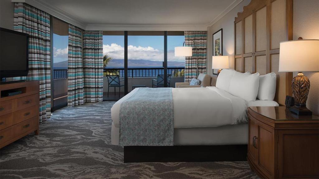 a hotel room with a bed and a television at Marriott's Maui Ocean Club Studio Oceanview in Lahaina