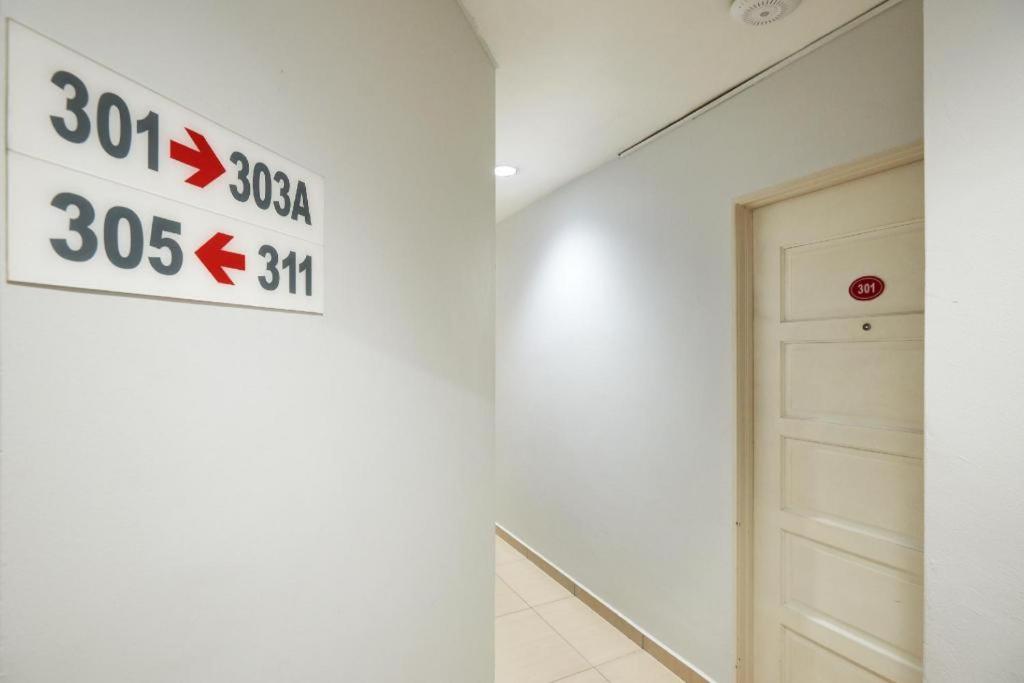 a sign on a wall in a room with a door at Swing & Pillows @ PJ KD in Sungai Way