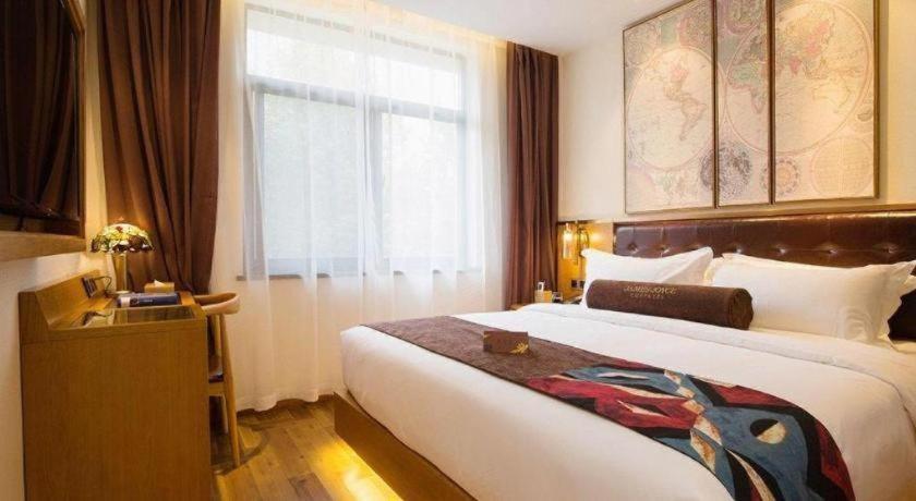 a hotel room with a large bed and a window at James Joyce Coffetel· Hefei Anhui Agricultural University in Hefei