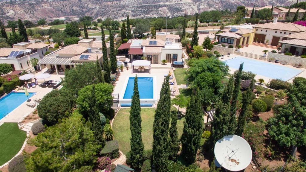 an aerial view of a house with a pool and trees at Villa UNIDERA in Kouklia