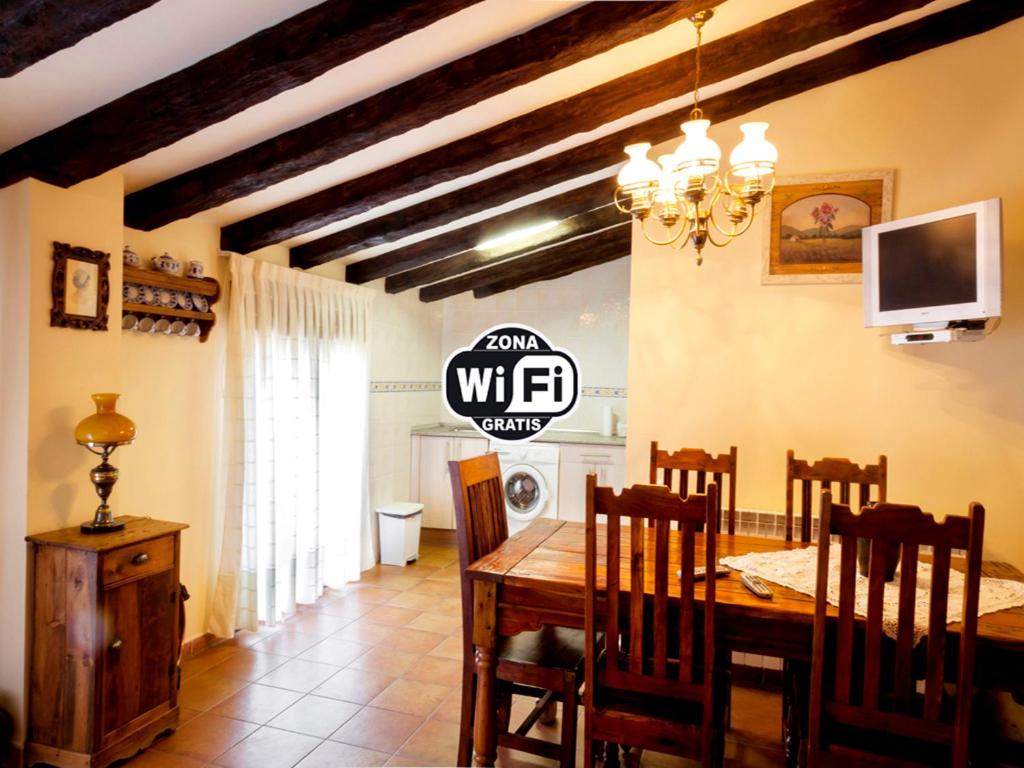 a dining room with a table and a tv at Casa rural zaragoza in Almonacid de la Sierra