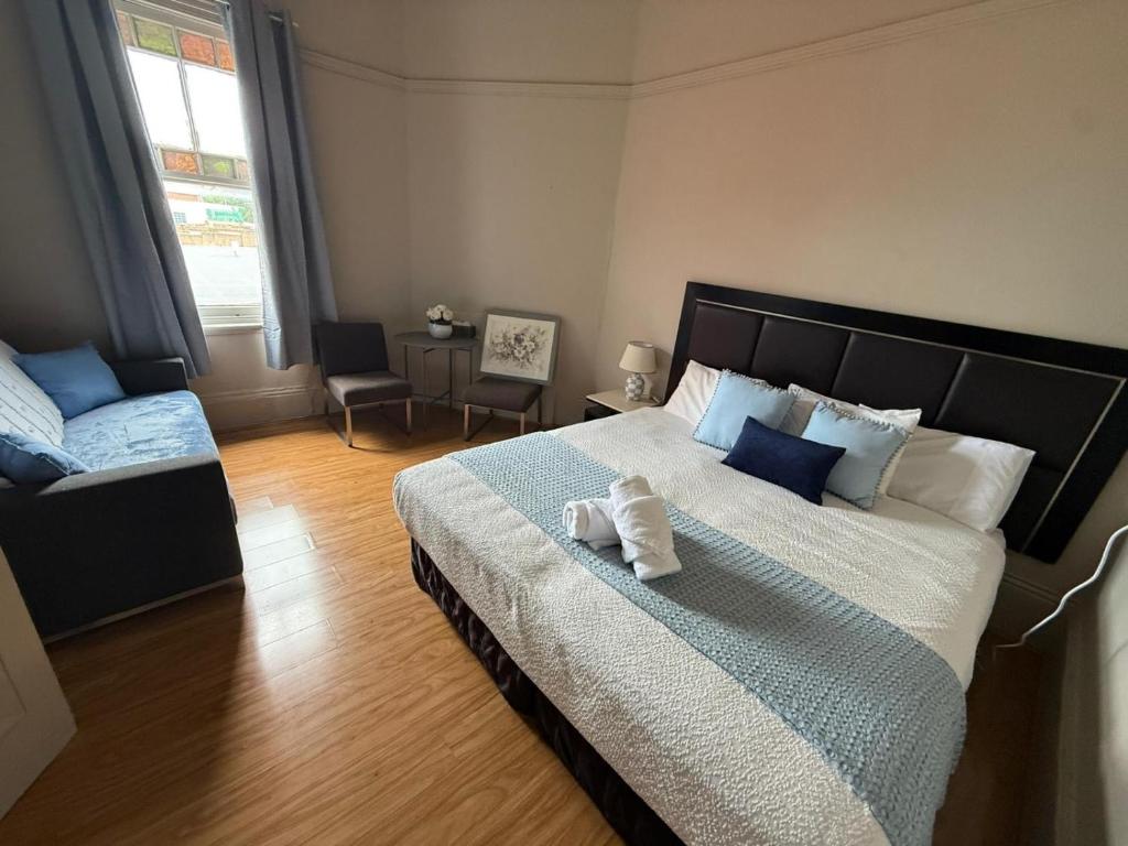 a bedroom with a large bed and a chair at Jerilderie Hotel in Jerilderie