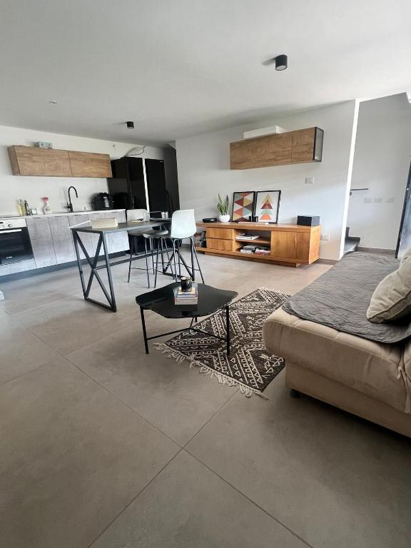 a living room with a couch and a kitchen at הסטודיו in Beer Sheva