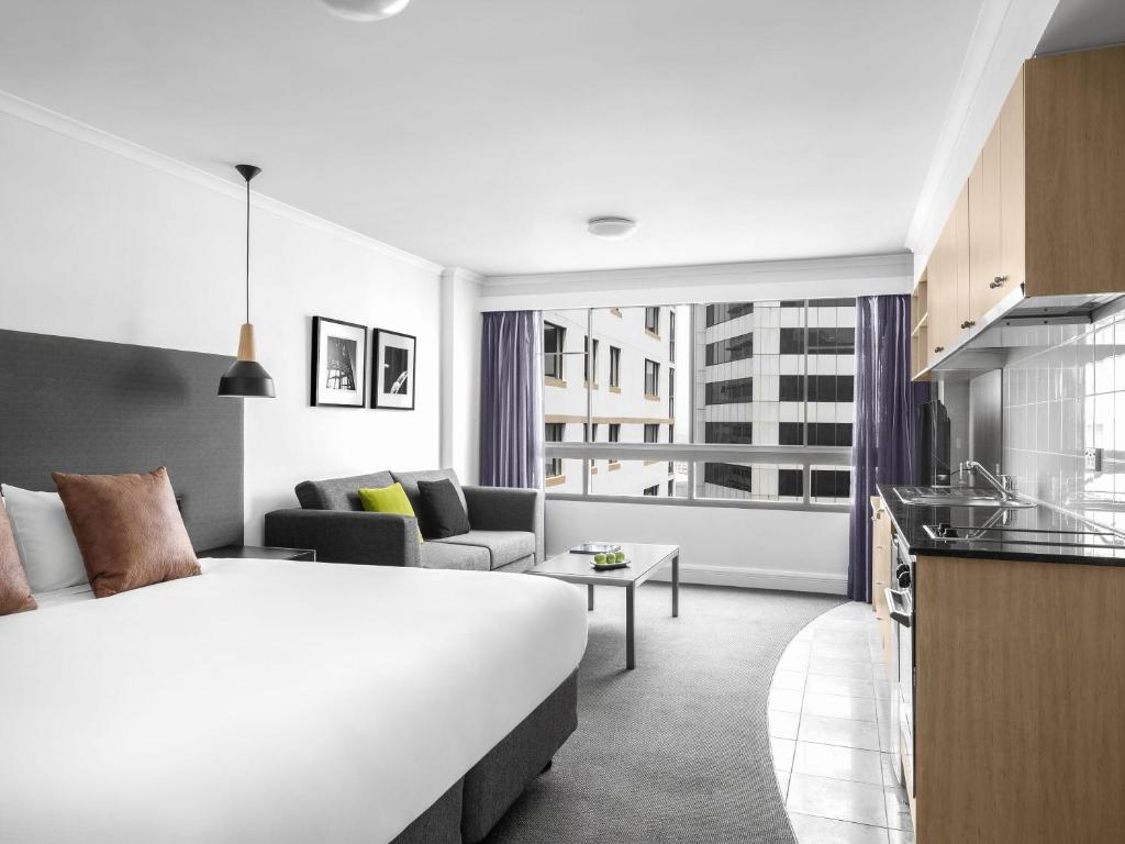 een hotelkamer met een groot bed en een keuken bij Mantra on Kent in Sydney