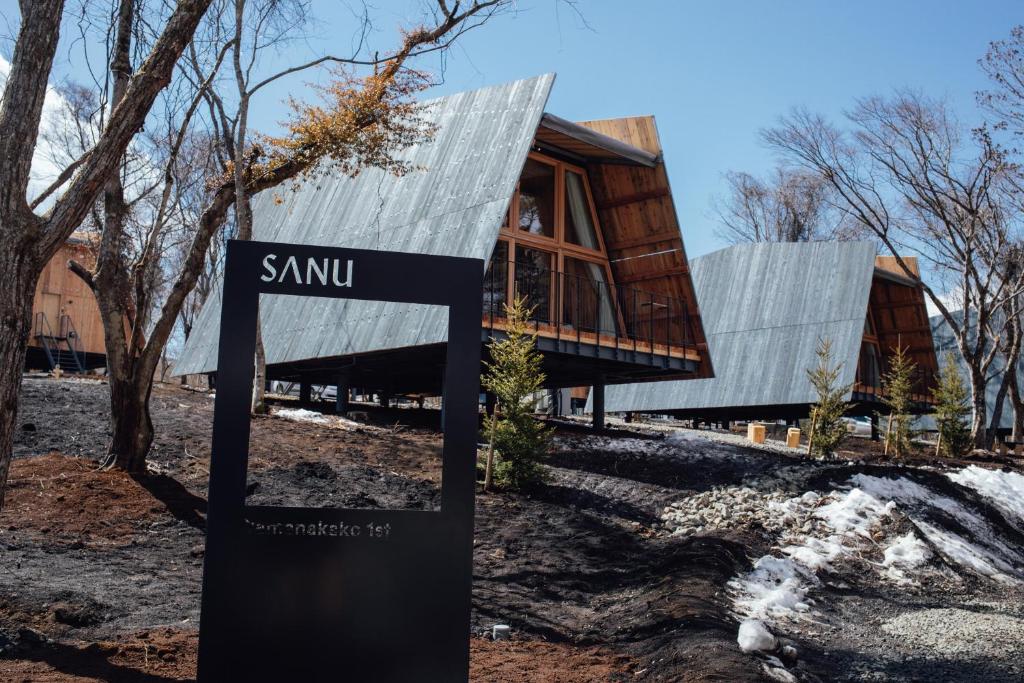 a house with a sign in front of it at SANU 2nd Home 山中湖1st in Yamanakako