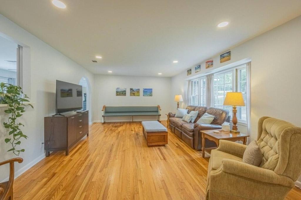 a living room with a couch and a tv at Restful Riverside Residence w Firepit in Athens