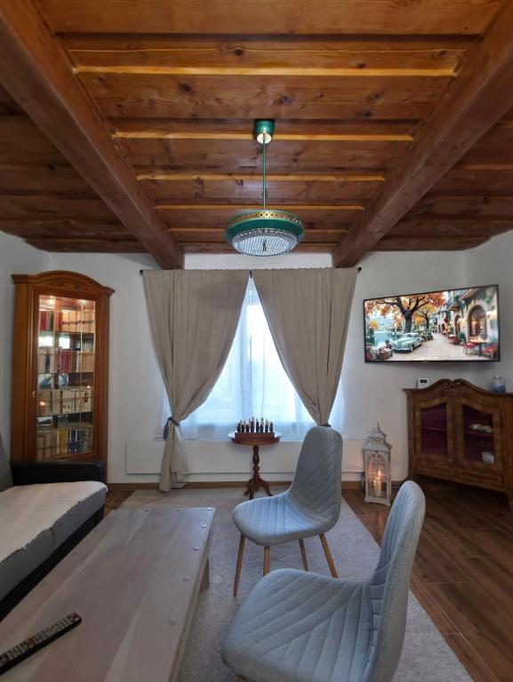 a living room with a couch and a tv at U Richtára in Klokoč