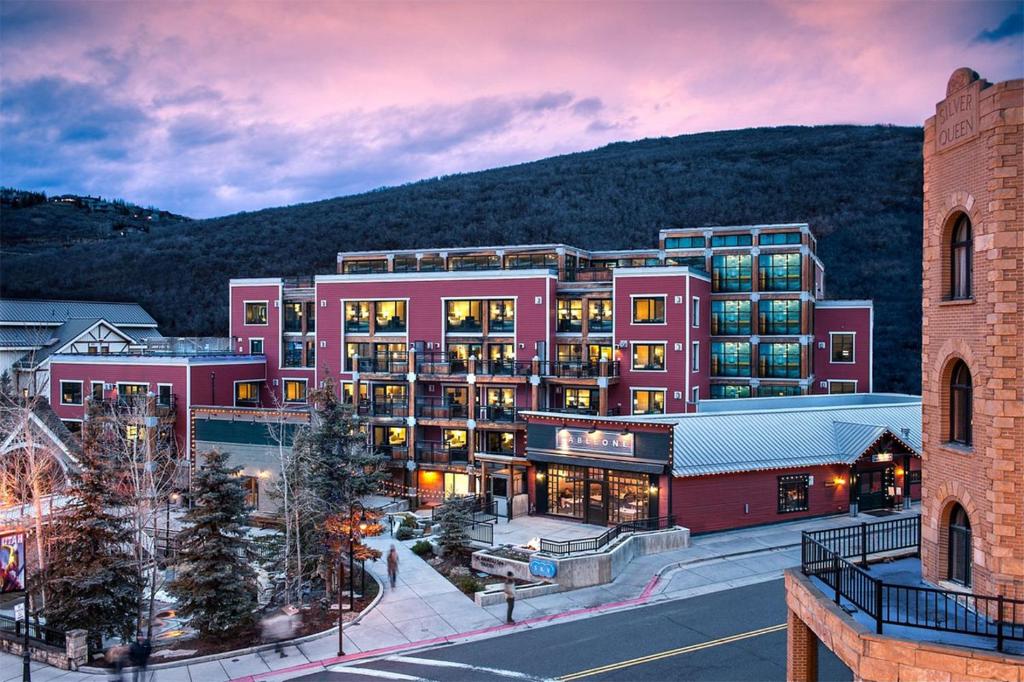 a large pink building with a mountain in the background at Main & SKY Park City Utah in Park City