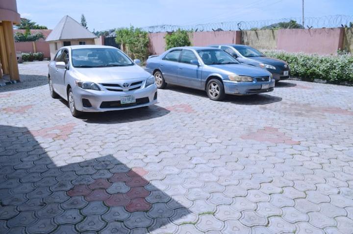 two cars are parked in a parking lot at Metroluxe in Akure