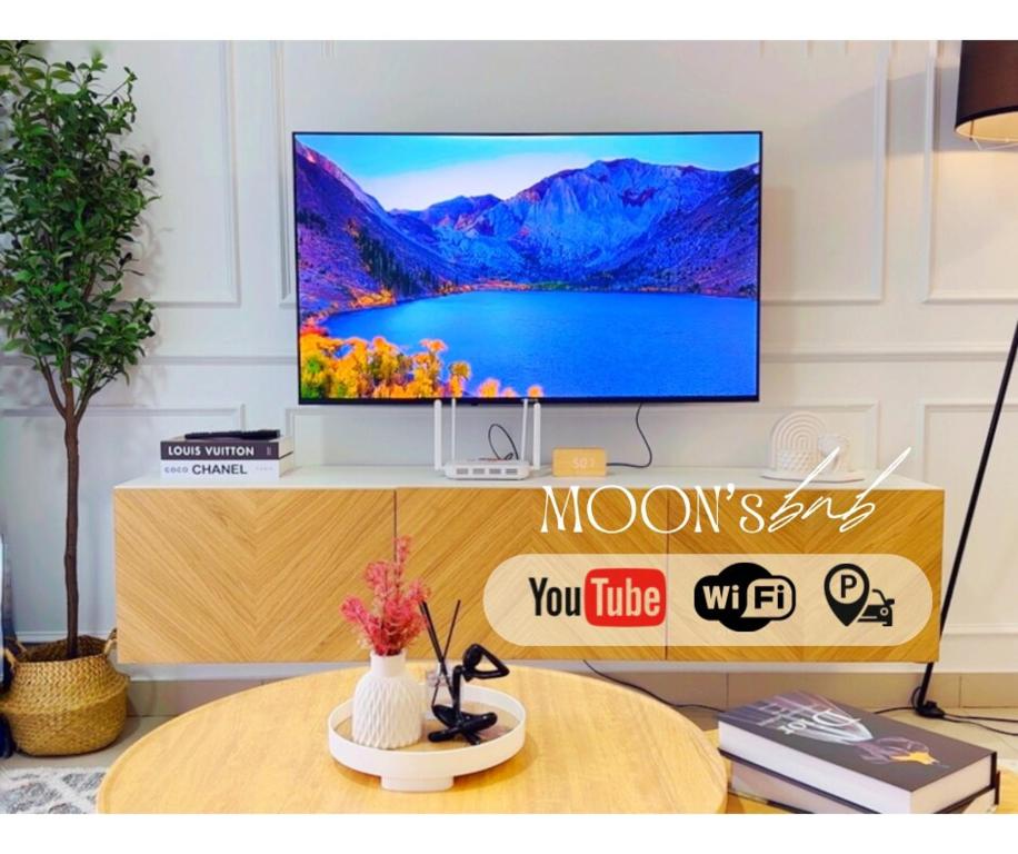 a living room with a tv and a table at Nadayu63 Melawati I 3R2B I 8Pax in Kuala Lumpur