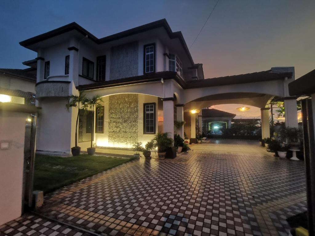 a large white house with a driveway at Room Only - RyuiBungalow 23'00-11'00 - Night Use - PROMO in Sungai Petani