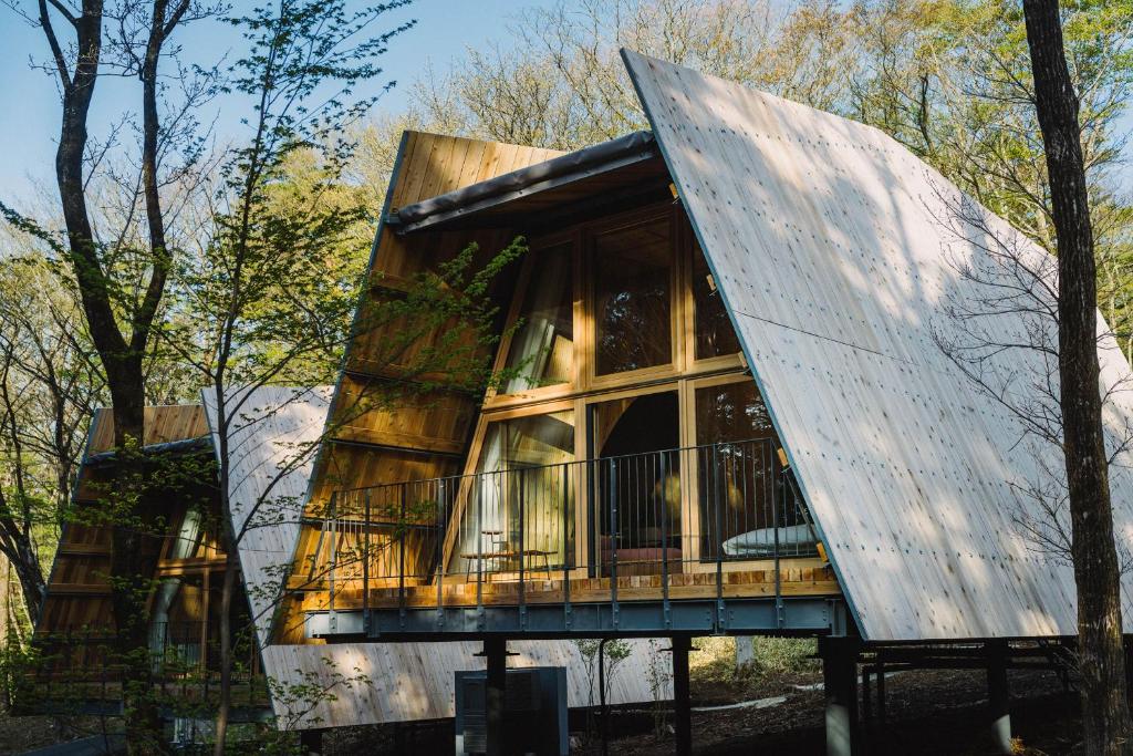 a tree house with a glass facade at SANU 2nd Home 那須2nd in Nasu