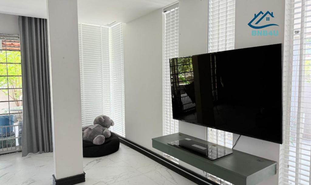 a teddy bear sitting in a room with a tv at Landed Spacious House at Cangkat Delima Gelugor Penang in Gelugor
