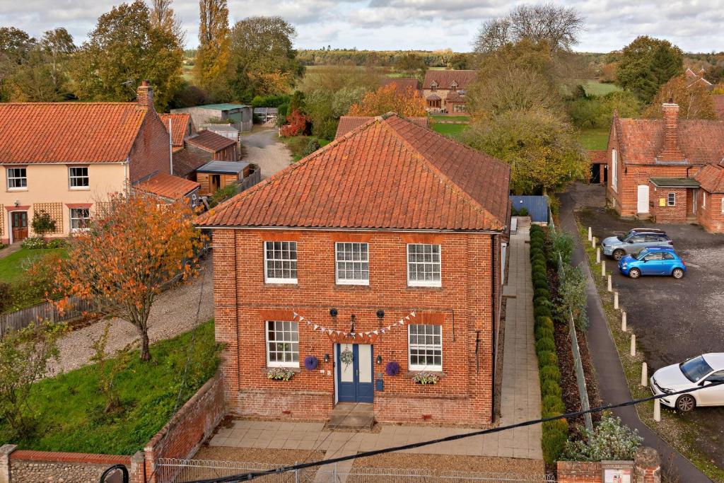 an aerial view of a brick house with a blue door at Finest Retreats - The Chapel in Hindolveston