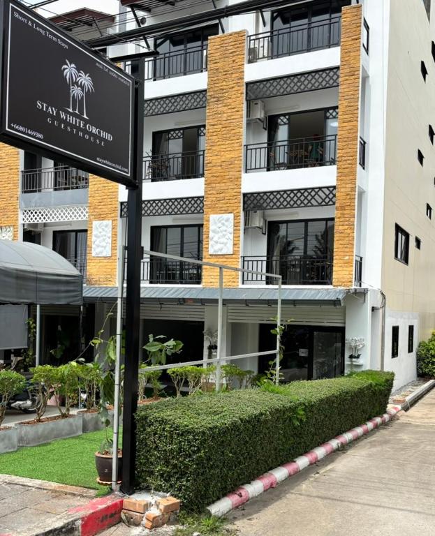 a building with a sign in front of it at Stay White Orchid in Krabi