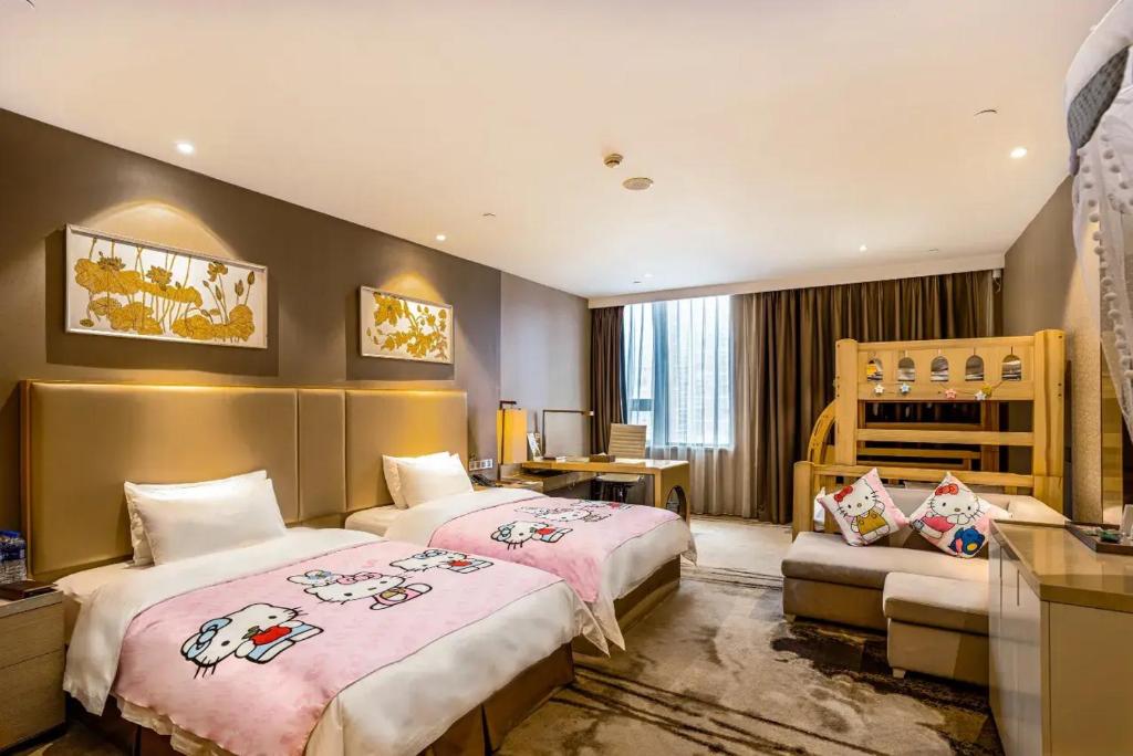 a hotel room with two beds and a desk at Gallery F Hotel in Wuhan
