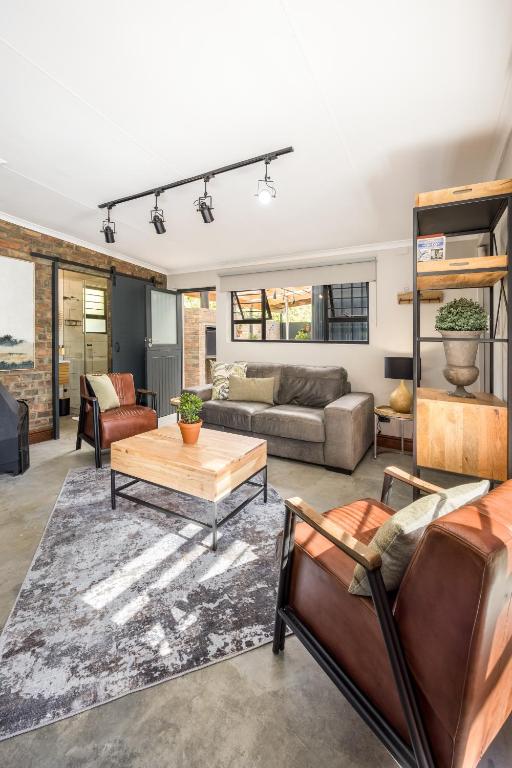 a living room with a couch and a table at Avemore Time Out Le Verger in Stellenbosch