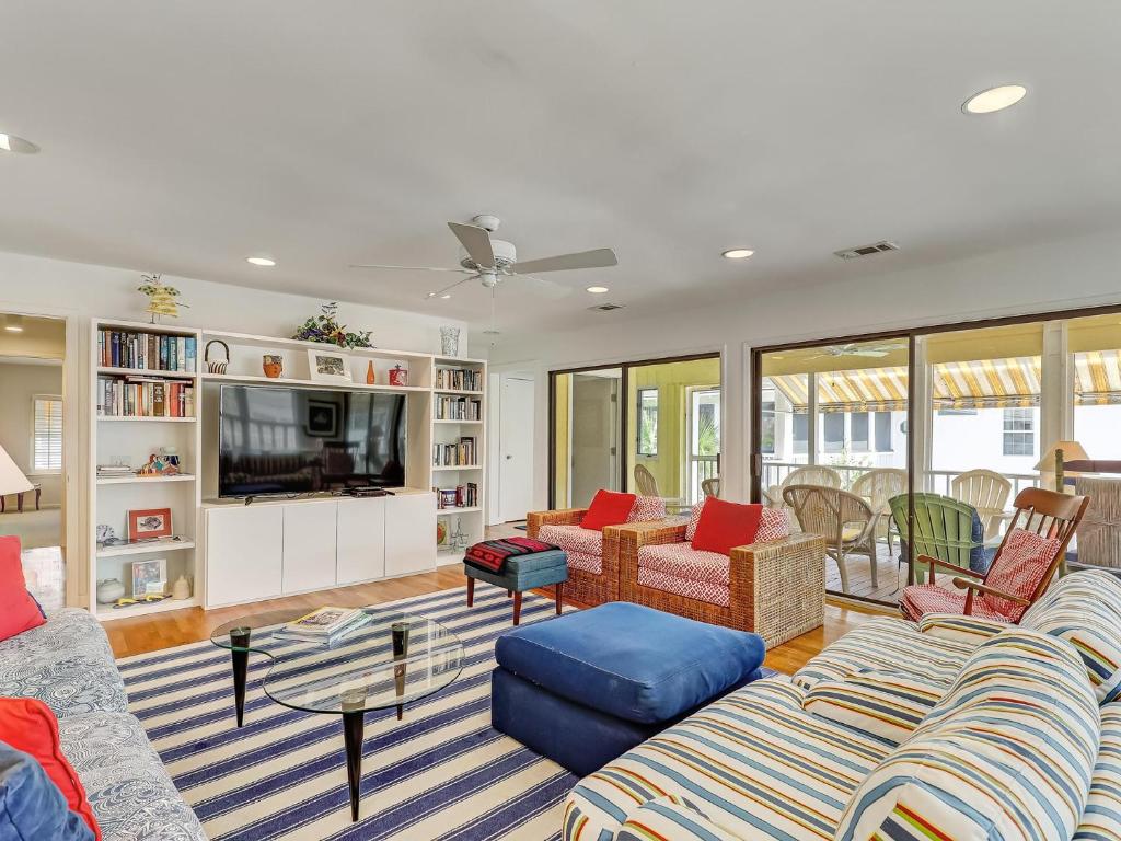 a living room with two couches and a tv at Coops Retreat Unit A in Tybee Island