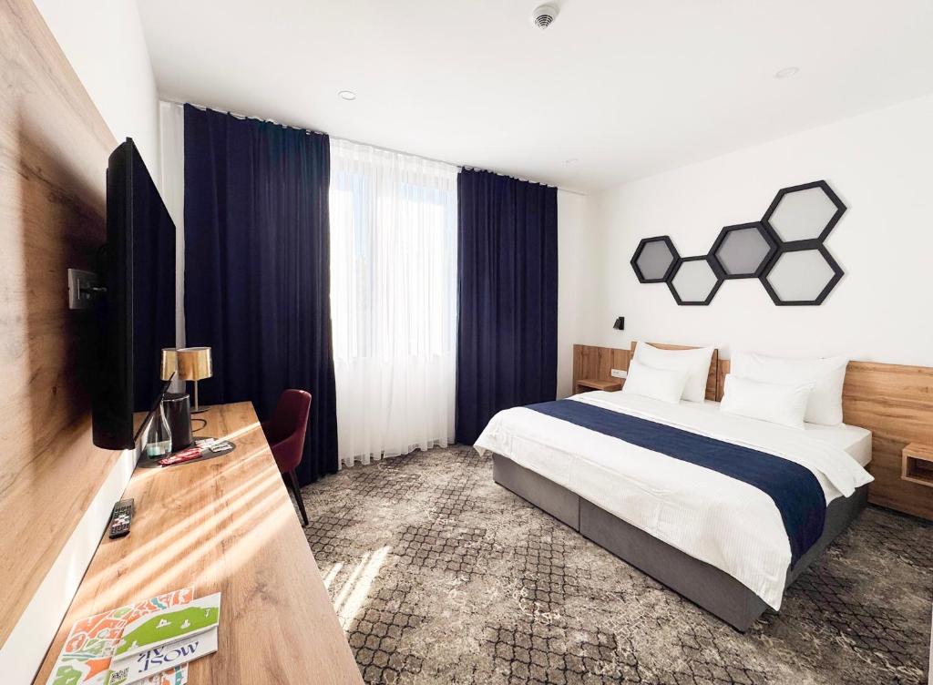 a hotel room with a bed and a television at Hotel Karting in Mostar