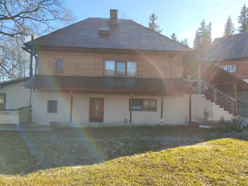 a house with a rainbow in front of it at Casa Dominic in Gîrda de Sus