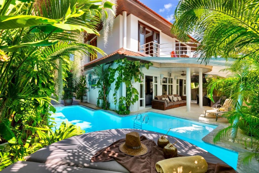 an exterior view of a villa with a swimming pool at 3 BR Pool Villa - Kids Paradise in a beachside resort in Choeng Mon Beach