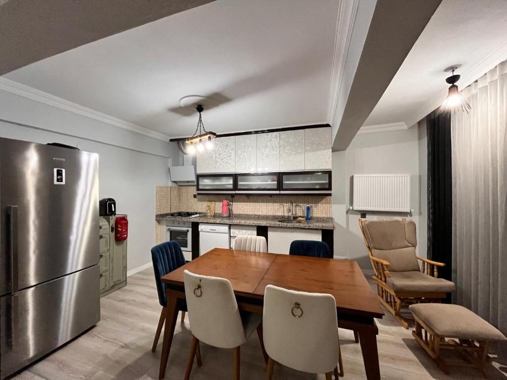 a kitchen and dining room with a wooden table and chairs at Quiet House in İznik