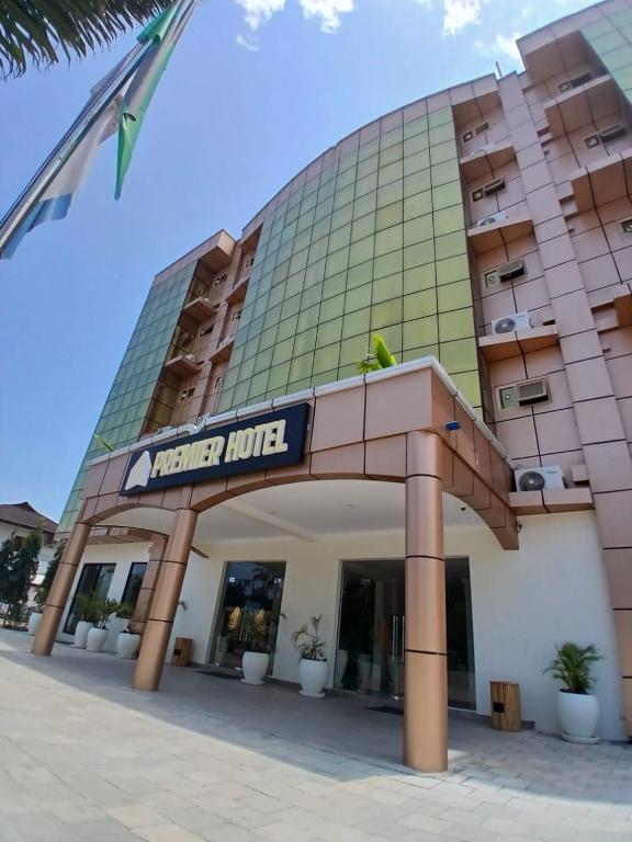a large building with a sign in front of it at Premier Hotel Zanzibar Airport in Zanzibar City