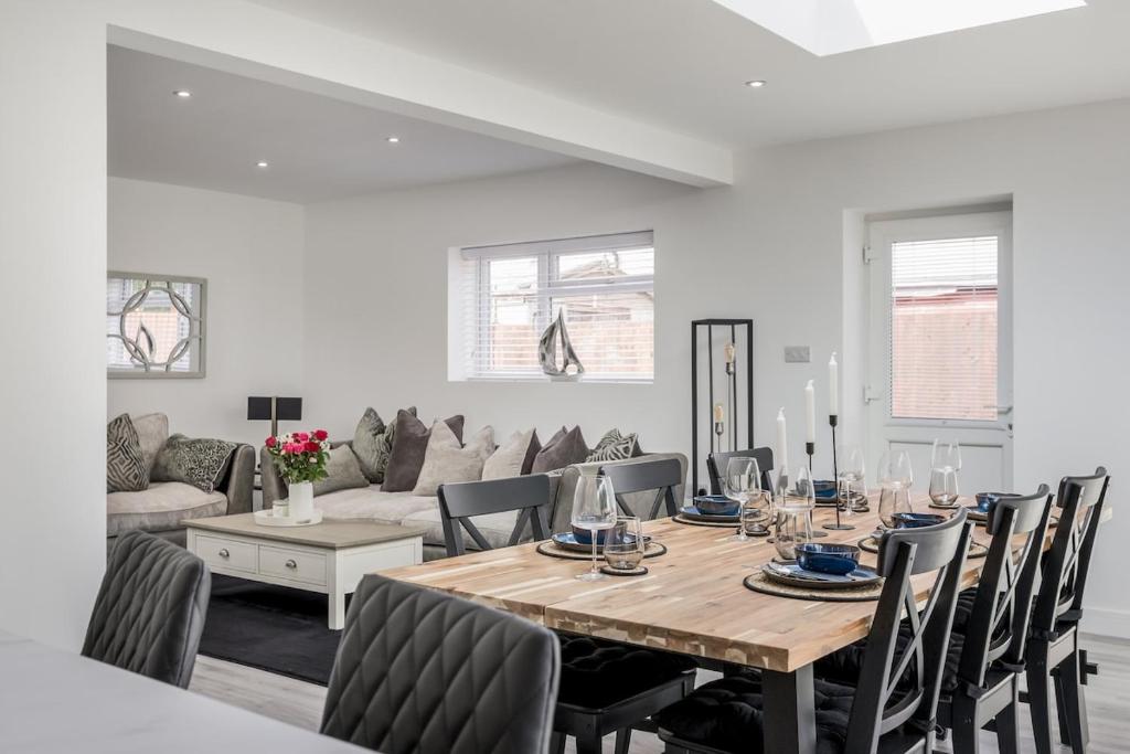 a dining room with a table and chairs at Seaside Bungalow with Garden & Inflatable Hot Tub in Hamworthy