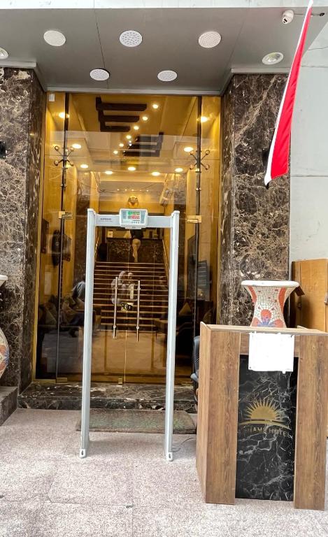 a window of a store with a table and a chair at City Sun Cairo Hotel in Cairo