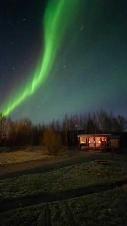 an image of the northern lights in the sky at Onnela Homestay Sauna Cottage in Rovaniemi