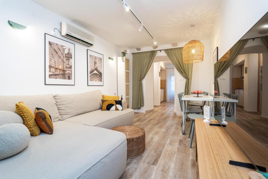 a living room with a white couch and a table at Villa LaPetra in Cavtat