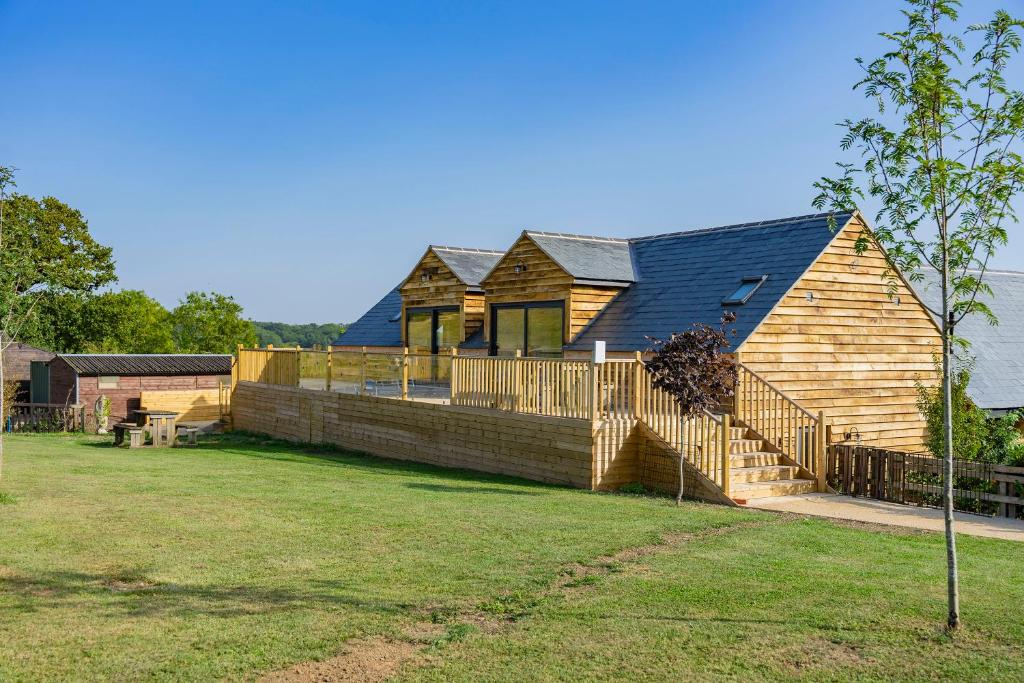 a wooden house with a fence in a yard at The Silvan Lodge, Peace, Privacy, and Pure calm 