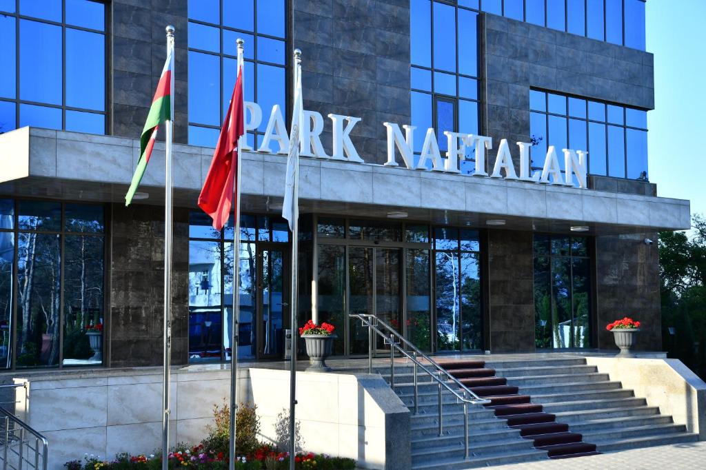 a building with flags in front of it at Park Naftalan Sanatoriya Kompleksi in Naftalan