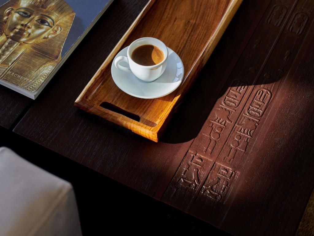 a cup of coffee on a tray on a table at Mövenpick Royal Lily Nile Cruise, Every Monday Four Nights From Luxor, Every Friday Three Nights From Aswan - Including Excursions & Sightseeing in Luxor